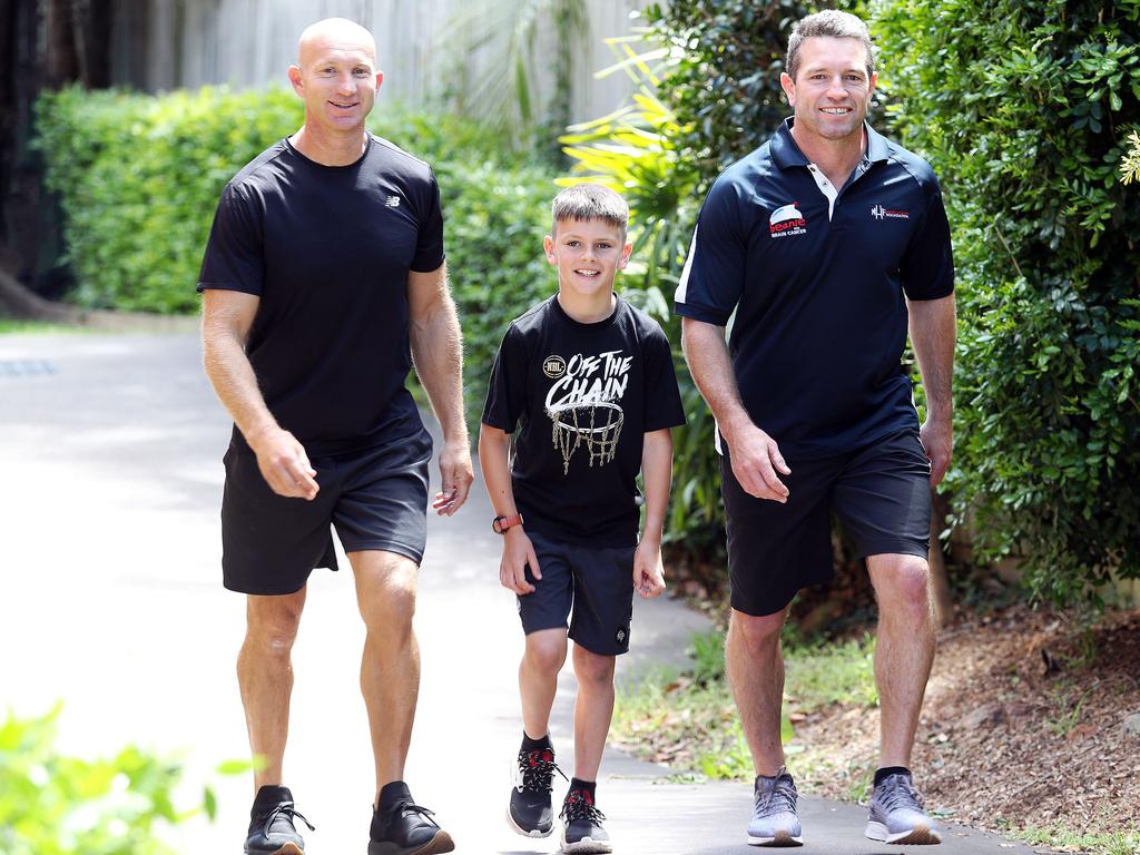 Adam MacDougall takes a walk with Danny Buderus and his son Lachlan, 8. Picture: Tim Hunter