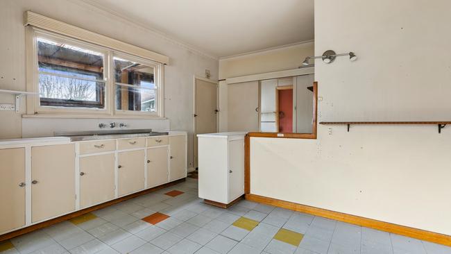 Original cabinets and linoleum floors create a blank canvas for new owners.