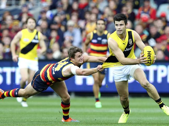 Matt Crouch desperately tries to hold onto Trent Cotchin. Picture Sarah Reed