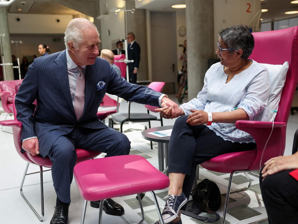 The King held hands with a patient at the cancer centre earlier this week. Picture: Suzanne Plunkett/Pool/AFP