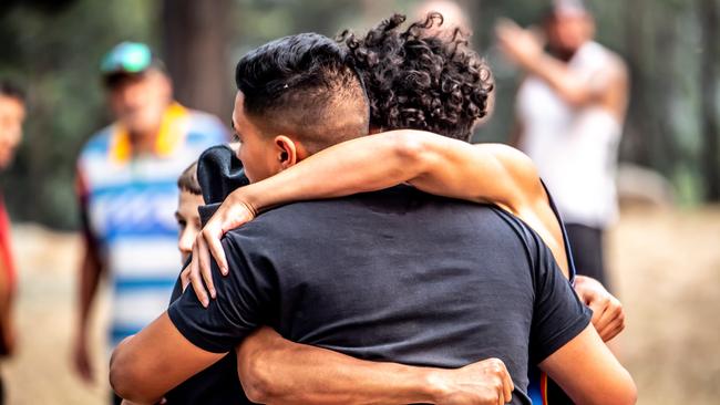 Grieving family and friends embrace after the body was found. Picture: Monique Harmer