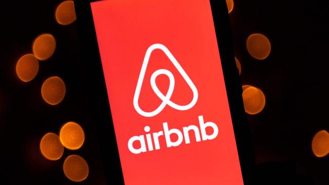 This illustration picture taken on November 22, 2019, shows the logo of the online lodging service Airbnb displayed on a smartphone in Paris. (Photo by Lionel BONAVENTURE / AFP)