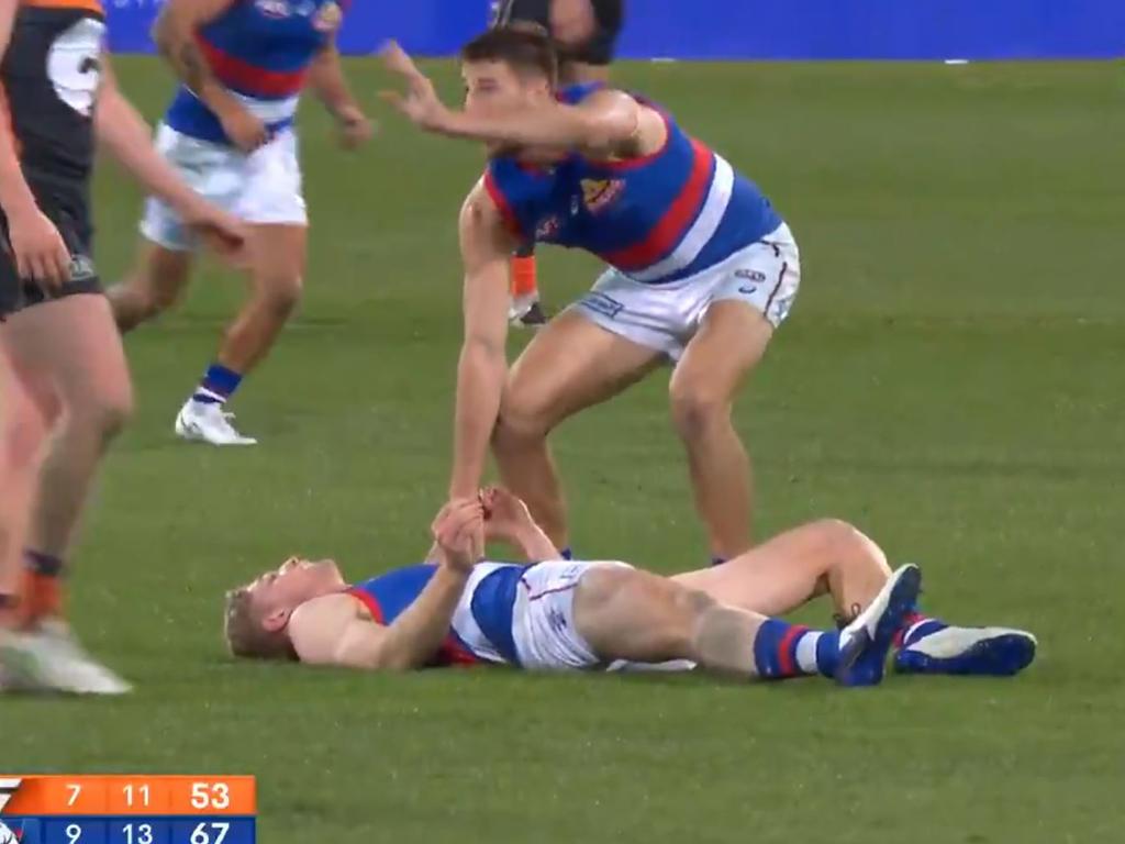 Marcus Bontempelli waves for a doctor after Tim English was floored.