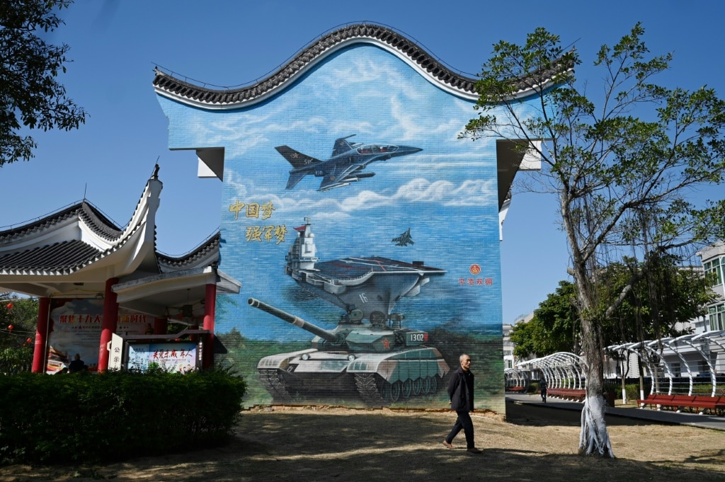 A man walks past a military-themed mural at a public park on Pingtan Island in China's southeast Fujian province, the closest point to Taiwan’s main island