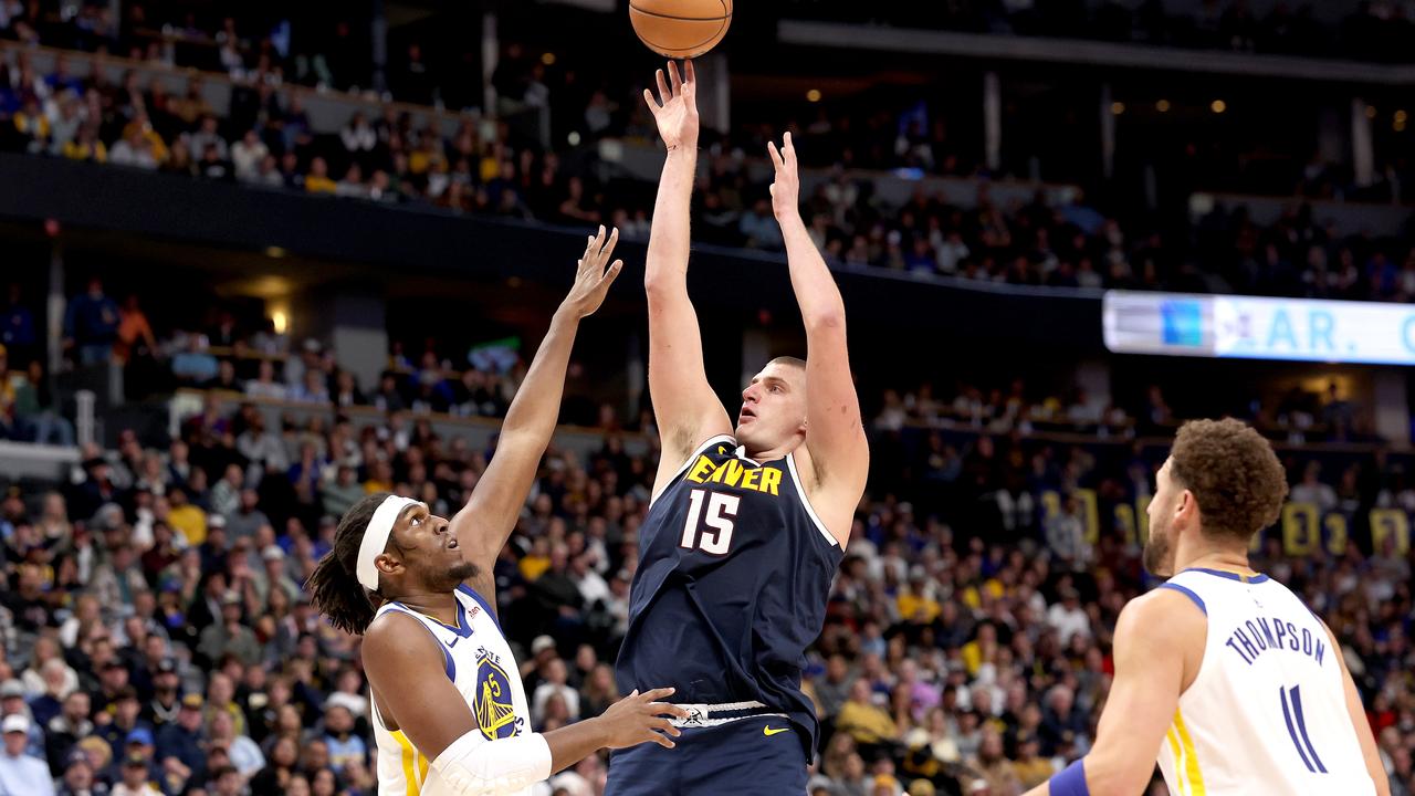 DENVER, COLORADO - NOVEMBER 08: Nikola Jokic #15 of the Denver Nuggets puts up a shot against Kevin Looney #5 of the Golden State Warriors in the fourth quarter at Ball Arena on November 08, 2023 in Denver, Colorado. NOTE TO USER: User expressly acknowledges and agrees that, by downloading and or using this photograph, User is consenting to the terms and conditions of the Getty Images License Agreement. (Photo by Matthew Stockman/Getty Images)