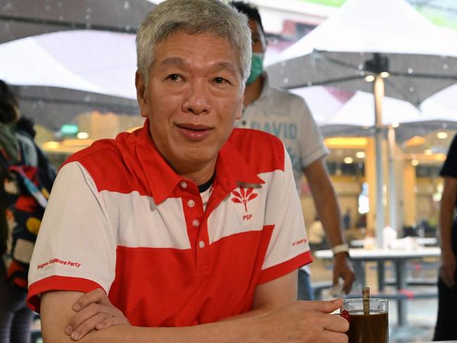 (FILES) Lee Hsien Yang, the brother of Singapore's then prime minister Lee Hsien Loong and son of the city state's founding father Lee Kuan Yew sits for a coffee after being presented membership to the opposition Progress Singapore Party during an event at the Tiong Bahru Market in Singapore on June 24, 2020. A bungalow where Singapore's early leaders spent long hours to lay the country's foundations is under the spotlight as a bitter feud rages between former prime minister Lee Kuan Yew's children. (Photo by ROSLAN RAHMAN / AFP)