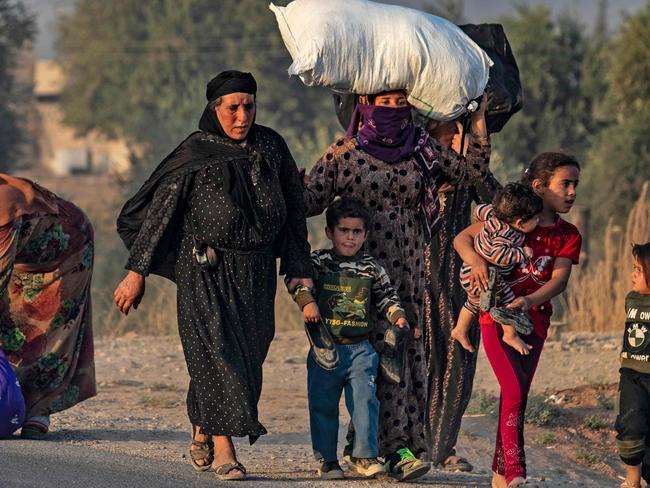 Civilians flee during Turkish bombardment on Syria's northeastern town of Ras al-Ain in the Hasakeh province along the Turkish border. Picture: AFP