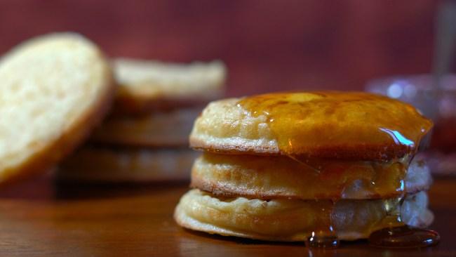 Hot Australian English style breakfast crumpets macro closeup, with honey dripping over the side.