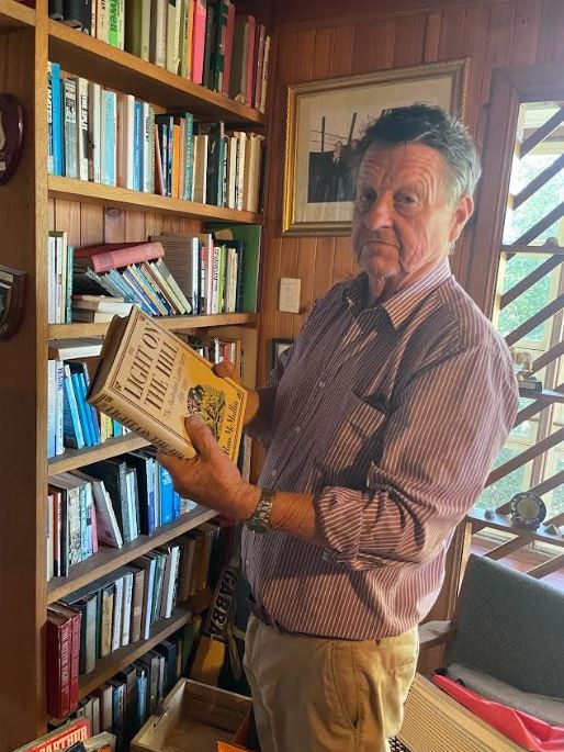 Rob Schwarten looks over the collection of political books at his Park Avenue home.