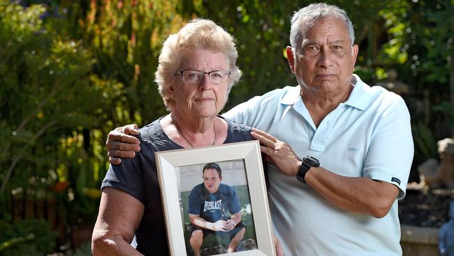 Julie and Jeffrey Tun Tin with a photo of murdered son, James. Picture: Naomi Jellicoe