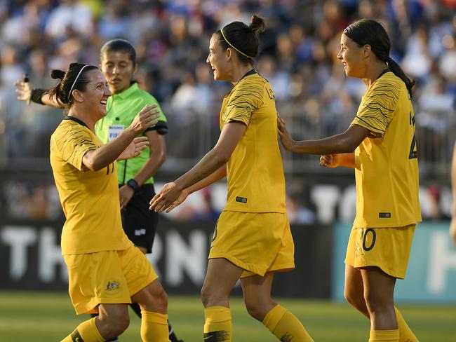 Australia's Chloe Logarzo, center, celebrates her goal with teammates Lisa De Vanna, left, and Sam Kerr, right, during a women's international soccer match against the United States, Sunday, July 29, 2018, in East Hartford, Conn. (AP Photo/Jessica Hill)