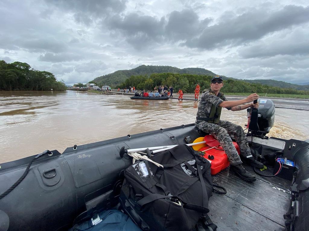 Royal Australian Navy personnel work with civilian emergency services to evacuate the public from Holloways Beach.