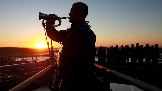 ***EXCLUSIVE TO DAILY TELEGRAPH. NO NEWS.COM*** A dawn service was held on the summit of the Sydney Harbour Bridge to commemorate ANZAC Day. Bugler and Leading seaman Marcus Salone plays The Last Post on top of the bridge. Picture: Toby Zerna