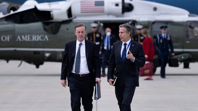 US National Security Advisor Jake Sullivan (L) and US Secretary of State Antony Blinken speak as they walk to Air Force One at Munich Airport in Munich.