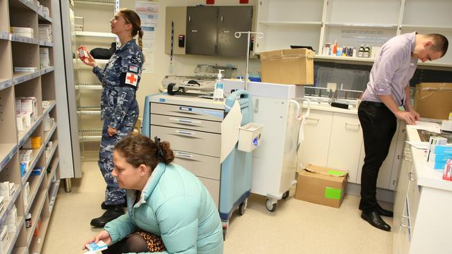 Royal Australian Air Force and Tasmanian Health pharmacists in the North West Regional Hospital after the hospital’s formal handover from contracted cleaning personnel after it was closed during the outbreak.