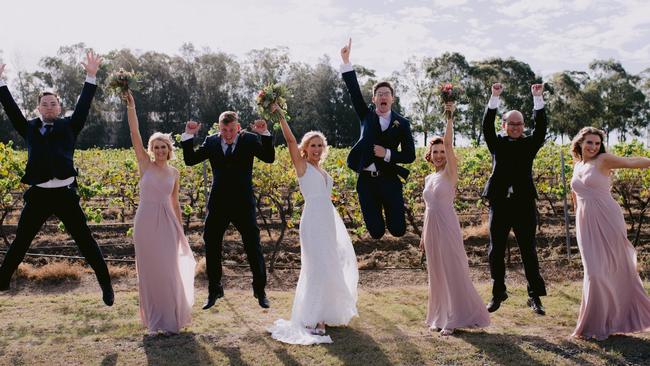 Jumping for joy: Kimberly Crawford and Kevin Camrass and bridal party. Picture: Tom Roberts Media