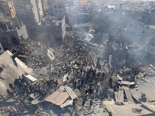 People search for survivors and the bodies of victims in the rubble of buildings destroyed during Israeli bombings in Khan Yunis in the southern Gaza Strip on Thursday. Picture: AFP