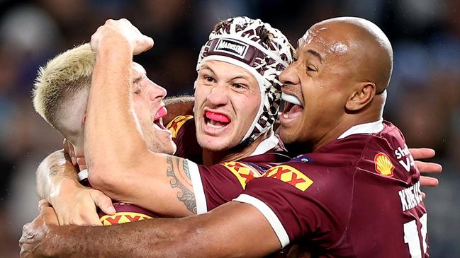 Felise Kaufusi, right, celebrates with Cameron Munster and Kalyn Ponga after Queensland’s win in Game I. Picture: Mark Kolbe/Getty Images