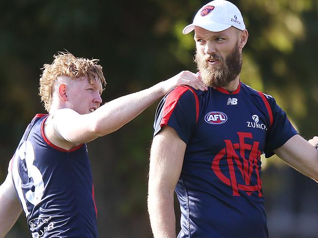 MELBOURNE, AUSTRALIA - MARCH 27: Max Gawn of the Demons  is hugged by Clayton Oliver (L) during a Melbourne Demons AFL training session at Gosch's Paddock on March 27, 2019 in Melbourne, Australia. (Photo by Michael Dodge/Getty Images)