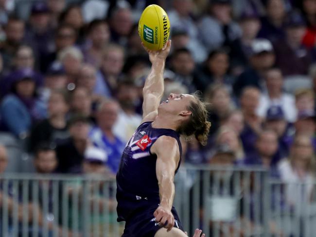 Nat Fyfe leaps high to mark. Picture: AAP