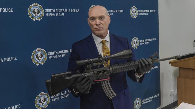 Detective Chief Superintendent Steve Taylor with a high-powered military rifle linked to the Comanchero bikie gang seized using intelligence gained during Operation Ironside. Picture: Roy Van Der Vegt