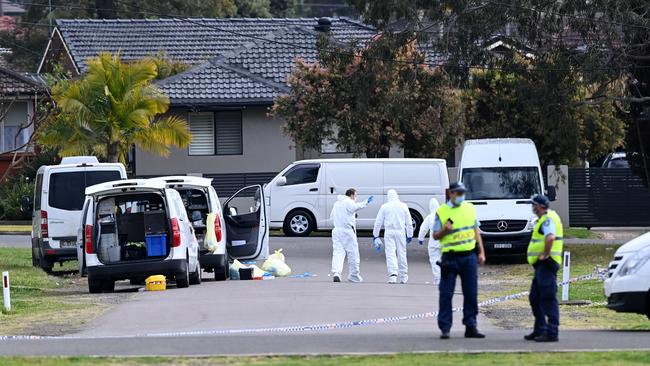 Police and forensic teams search the streets at the crime scene of the fatal stabbing. Picture: Jeremy Piper