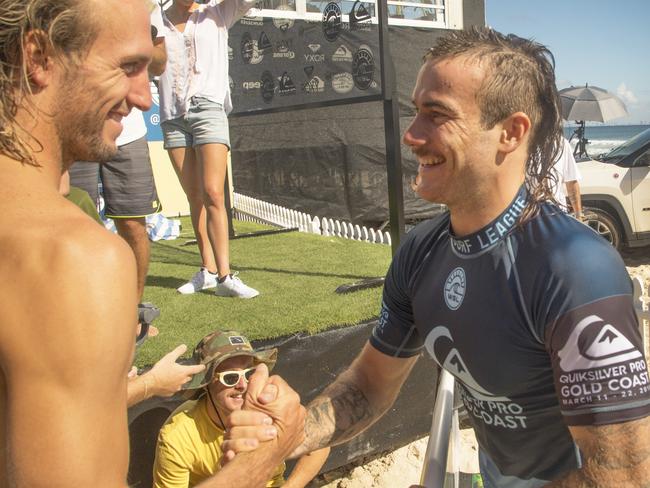 Mikey Wright, sporting his stunning mullet, greets brother Owen.