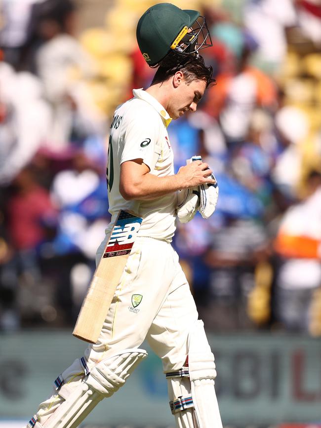 Pat Cummins heads off after being dismissed on day three.