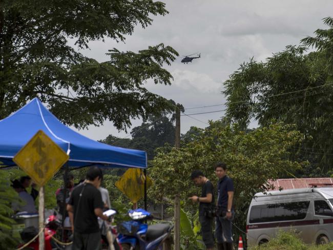 A Thai military helicopter flies over the Tham Luang cave area as operations continue for the eight boys and their coach still trapped at the cave in Khun Nam Nang Non Forest Park. Picture: AFP