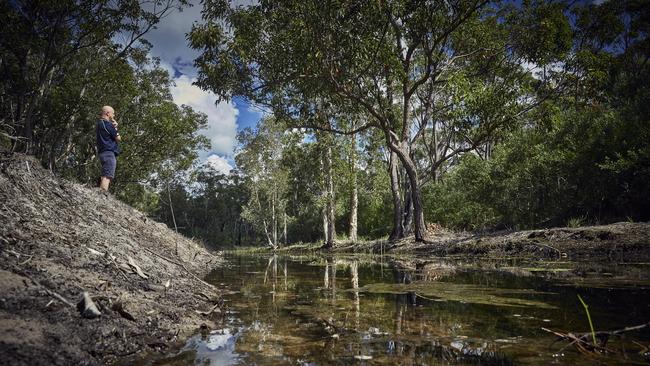 Rob Roseworne looks over a contaminated water channel that backs onto his property at Salt Ash, a few kilometres from the RAAF base in Williamtown. Picture: Nick Cubbin