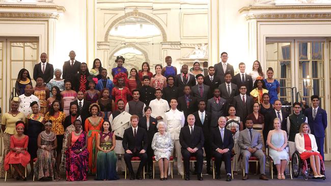 Queen Elizabeth II accompanied by Prince Harry, the Duke of York and former prime minister John Major, posing with the Queen's Young Leaders Awards recipients. Picture: Getty Images