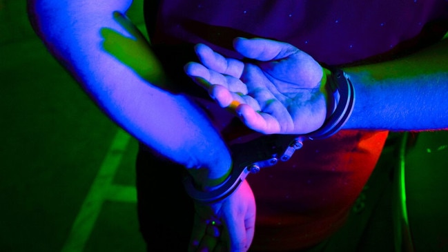 Cairns police generic handcuffs night