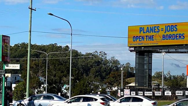 Michael Hart's billboard about opening the Queensland border. Photo: Supplied.