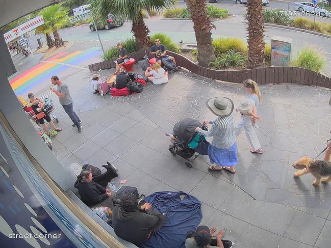 People walk past the homeless in St Kilda.