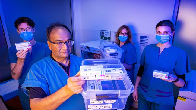 Dr Mukesh Haikerwal with Ryan Mitchell, Jenny Klenidis and Chloe Coffin at the Altona North Respiratory Clinic with vaccines close to their use by date. Picture: Mark Stewart