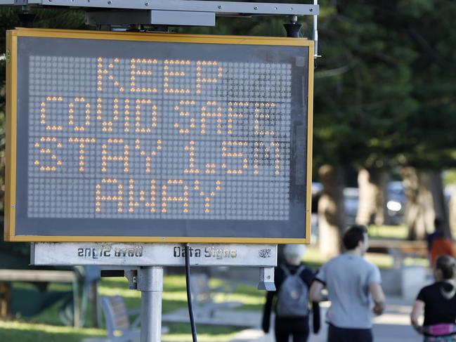 SYDNEY, AUSTRALIA - NewsWire Photos AUGUST 2: People out near Manly Wharf with a Covid warning sign pictured on the left.Picture: NCA NewsWire / Damian Shaw