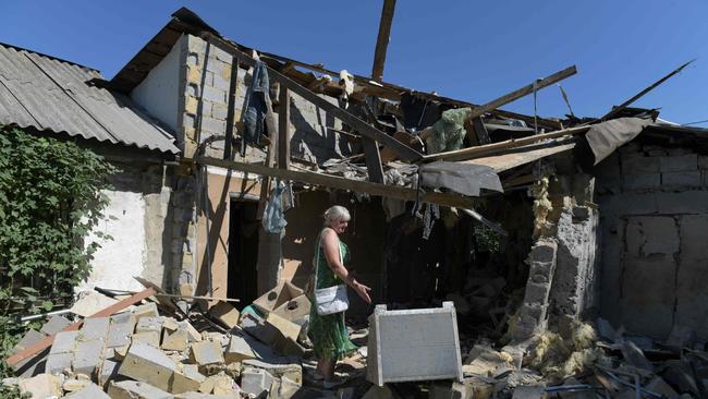 Lyubov Tolchina, 63, among the rubble strewn in the garden of her son's home, killed during Ukrainian shelling of Russian controlled Donetsk. Picture: AFP