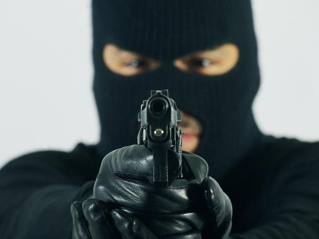 Man in mask aiming gun