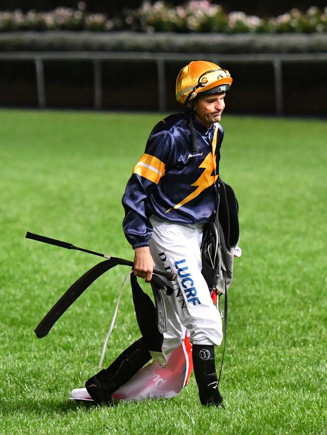 Jockey Dwayne Dunn walks off the track after Chautauqua was scratched at the barrier at Moonee Valley. Picture: Getty