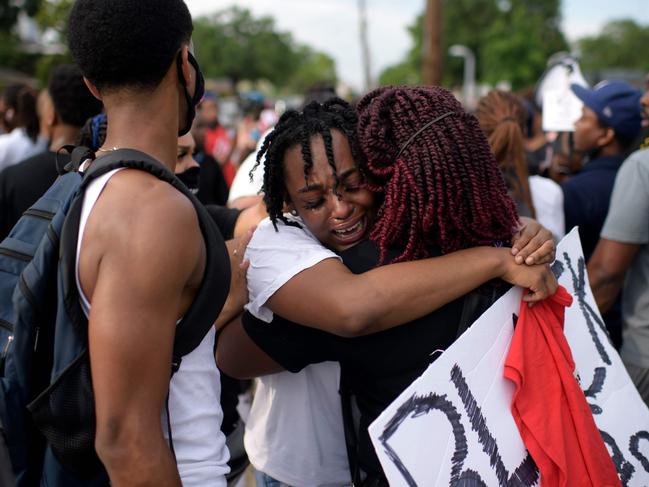George Floyd's niece Gabrielle Thompson (C) cries as she hugs another woman during a 