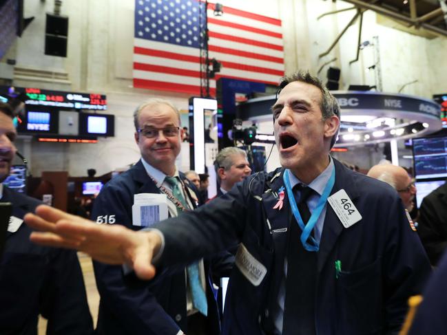 Traders work on the floor of the New York Stock Exchange as investors show growing concern about a slowing global economy.