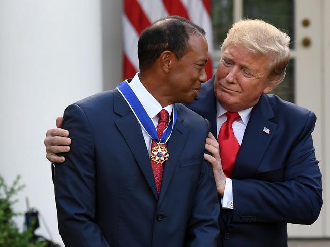 US President Donald Trump presents US golfer Tiger Woods with the Presidential Medal of Freedom during a ceremony in the Rose Garden of the White House in Washington, DC, on May 6, 2019. (Photo by SAUL LOEB / AFP)