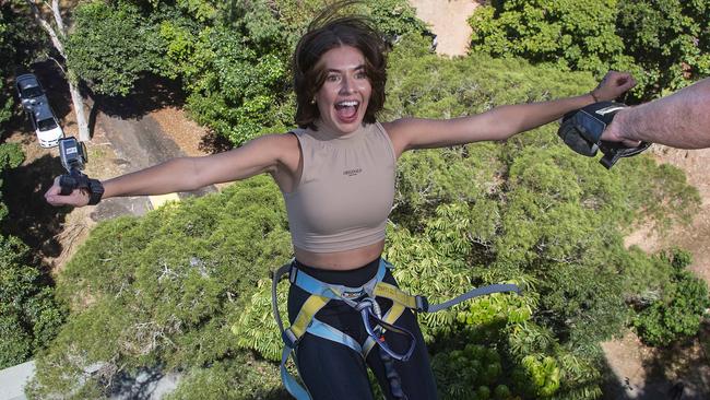 Cairns hospitality worker Lucy Smith, 22, bungee jumps at the city’s Smithfield SkyPark amusement centre. Picture: Brian Cassey