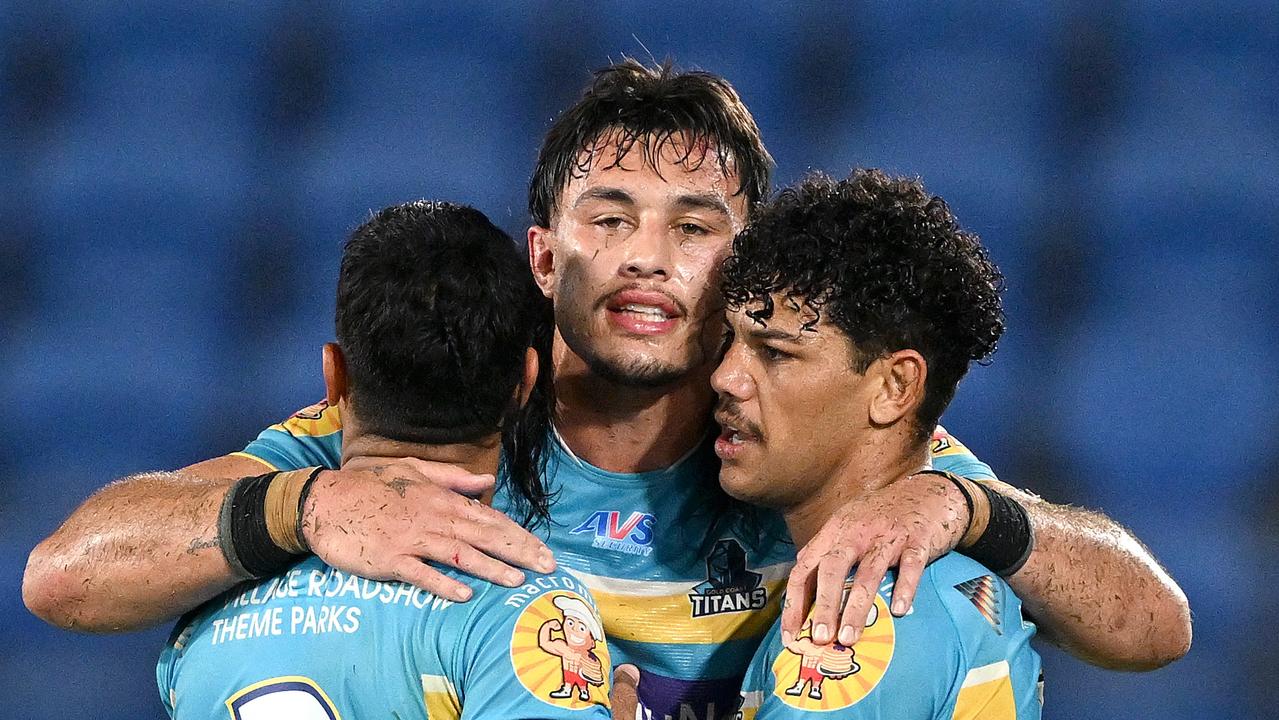 GOLD COAST, AUSTRALIA – JUNE 08: Tino Fa'asuamaleaui of the Titans celebrates victory with teammates Alofiana Khan-Pereira and Brian Kelly after the round 15 NRL match between Gold Coast Titans and Wests Tigers at Cbus Super Stadium on June 08, 2023 in Gold Coast, Australia. (Photo by Bradley Kanaris/Getty Images)