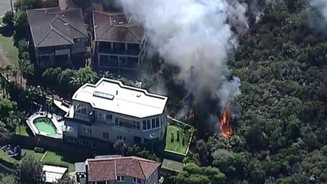 Hazard reduction burning on Sydney's northern beaches has gotten out of control, threatening homes near Curl Curl Beach. Picture: Nine News