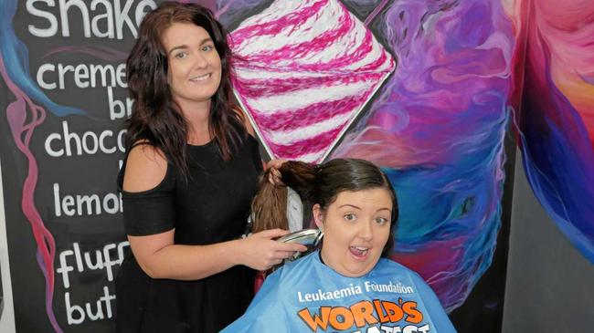 BUZZED: The Hair Hub Cafe manager Danielle Rosin practices her skills on hairdresser Maeghan Cornish. Picture: Eden Boyd