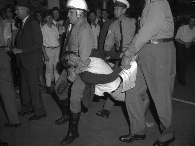 1966: A youth is carried away by police during a demonstration against conscription in Queen Street, Brisbane. Picture: Bruce Postle/File