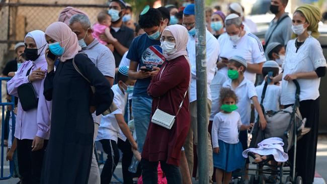 Muslims and Jews wait outside Israel's Magen David Adom medical service for a rapid Covid-19 test in Jerusalem. Picture: AFP