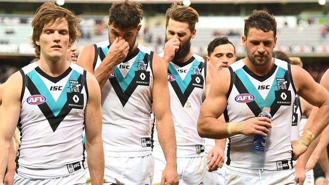 Port Adelaide players walk off the MCG after their loss to Melbourne. (AAP Image/Julian Smith)