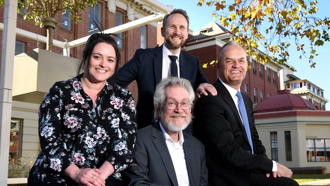 MIT Professor Alex "Sandy" Pentland (front, seated) flanked by artificial intelligence specialist Irene Prodromou, Optus Business managing director Simon Vatcher and BankSA chief executive officer Nick Reade in front of Lot Fourteen — the site that will house MIT’s new living laboratory. Picture: Tricia Watkinson